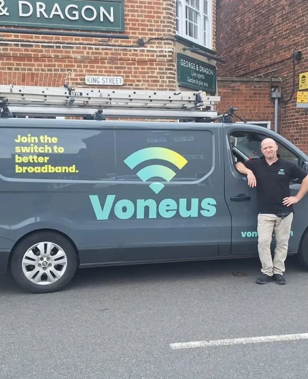 Voneus staff with a branded van in a rural Central England community