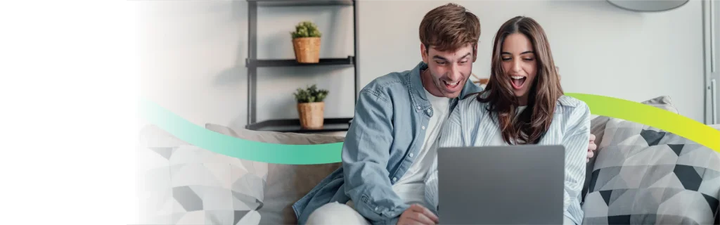 Couple using a laptop at rural home with best Voneus broadband.