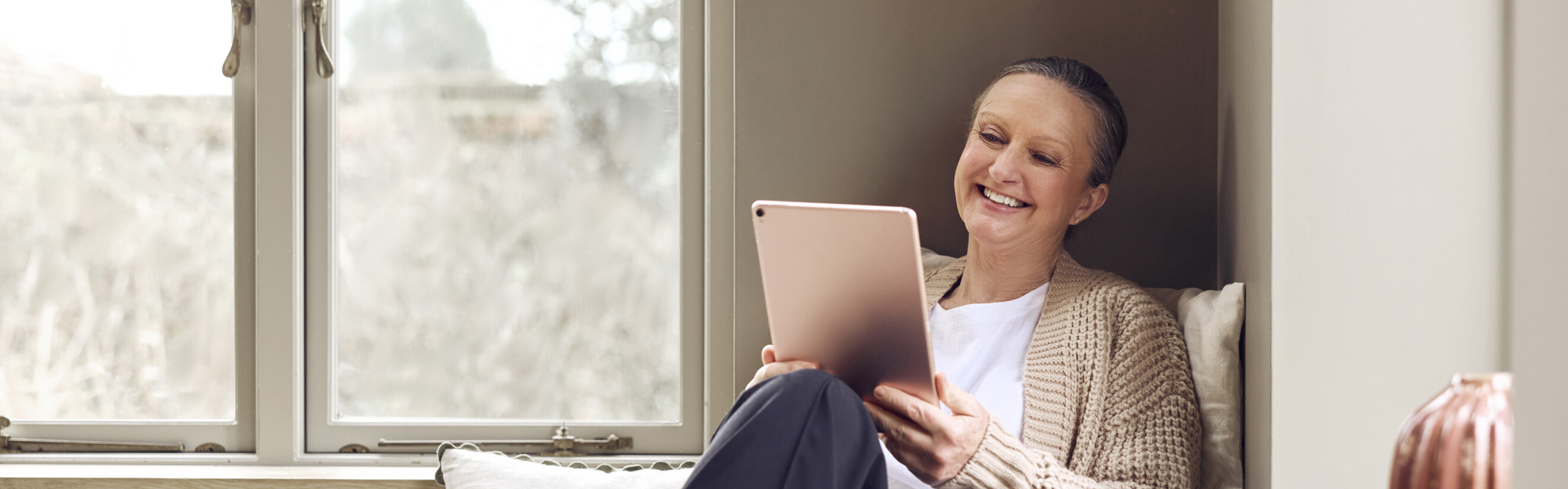 Happy woman streaming video on a tablet