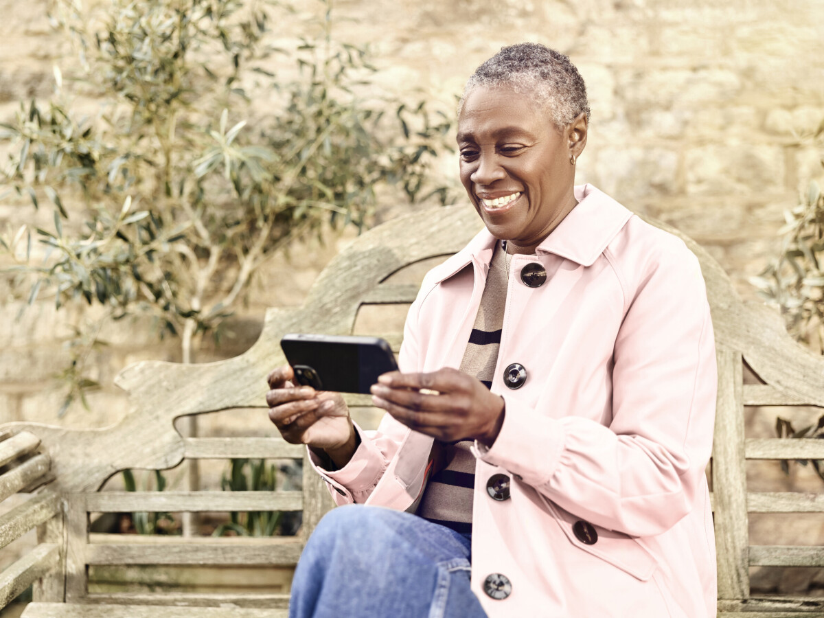Lady using wifi broadband in the garden