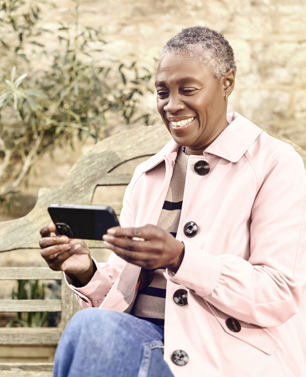 Lady using wifi broadband in the garden