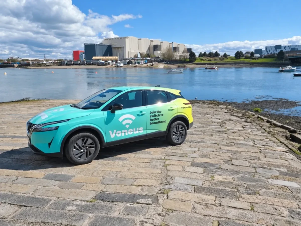 Voneus field agent with a branded vehicle supporting communities in the North of England