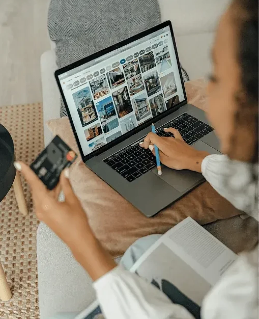 Person using a laptop and smartphone protected by Norton 360 online security