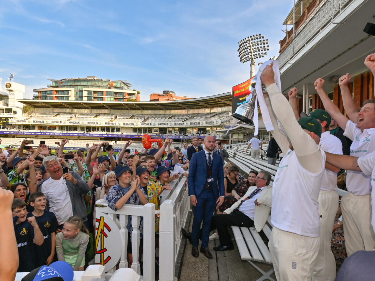 The village cup being lifted to a roaring crowd at Lords cricket ground in London