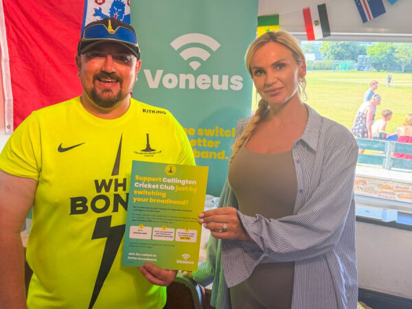 A Voneus member of staff stood with someone from Callington cricket club to promote Voneus broadband.