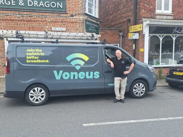 Voneus broadband engineer standing beside a branded service van, representing local broadband installation and support for Crickhowell and surrounding villages.
