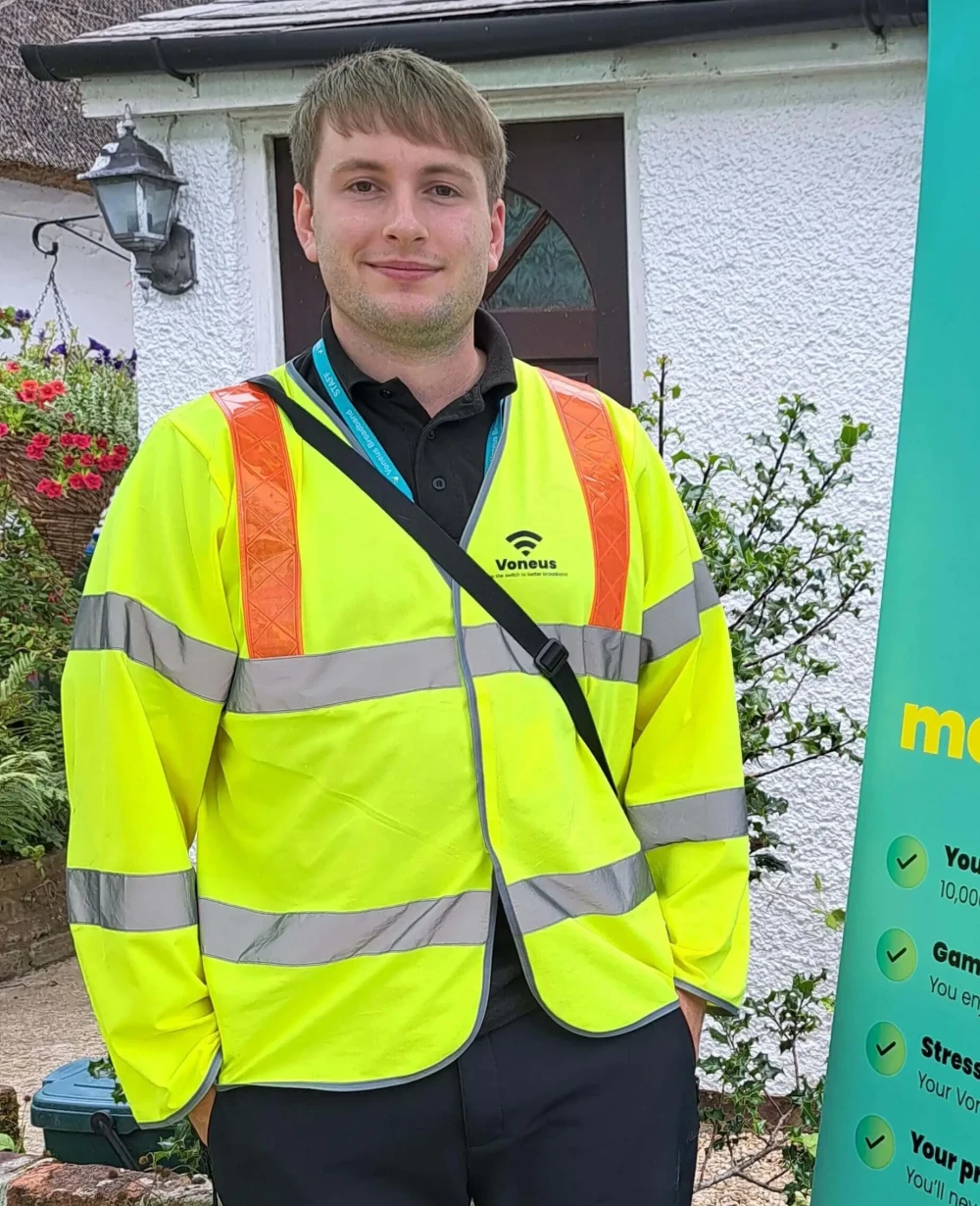 Voneus Broadband team member wearing branded high-visibility clothing at a local community event, helping residents in Church Stretton, explore their broadband options.