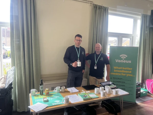 Two Voneus Broadband team members at a community drop-in session with promotional materials, helping residents in Pontesbury, Stiperstones and surrounding villages explore their broadband options.