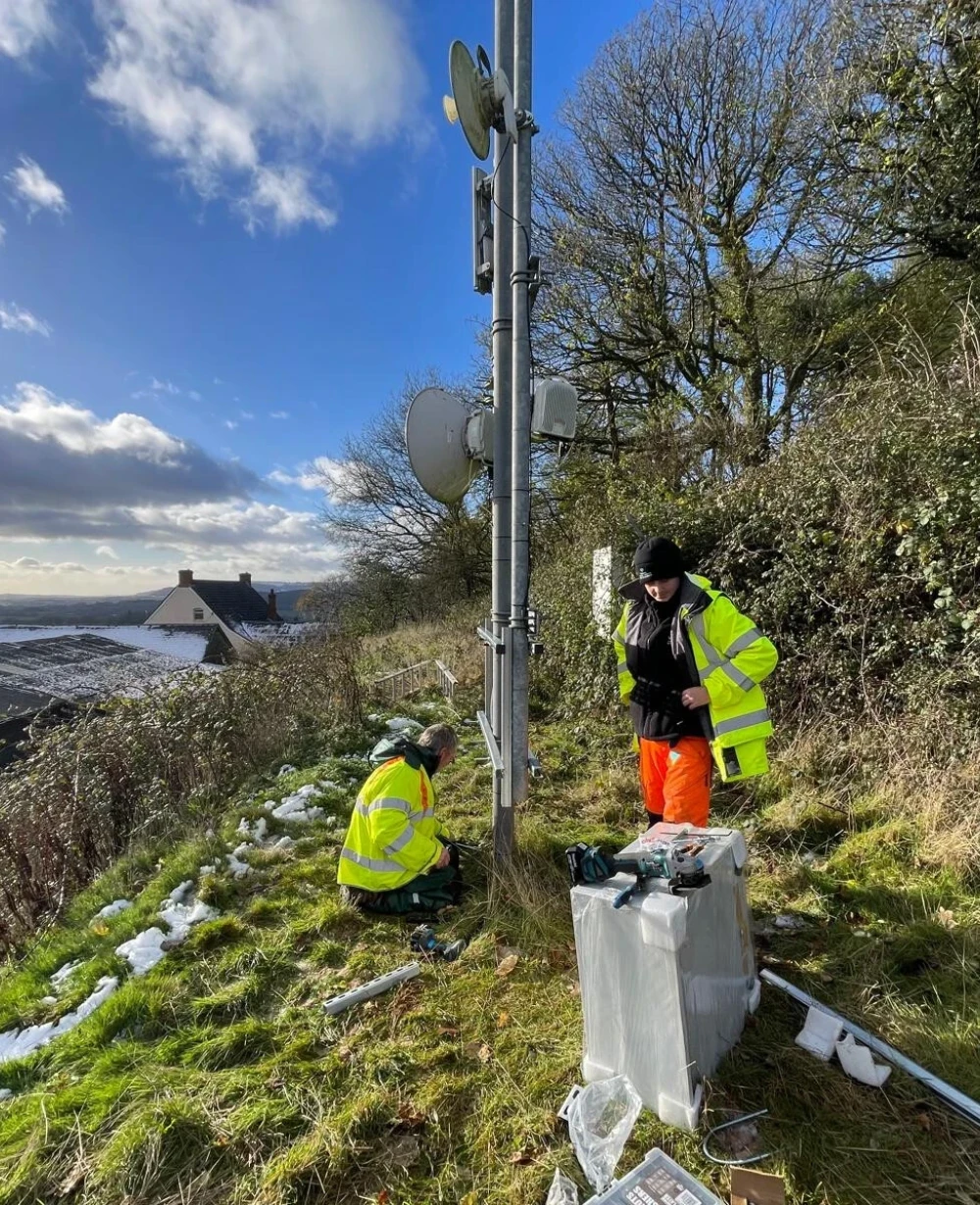 Voneus engineers installing broadband equipment in a rural community