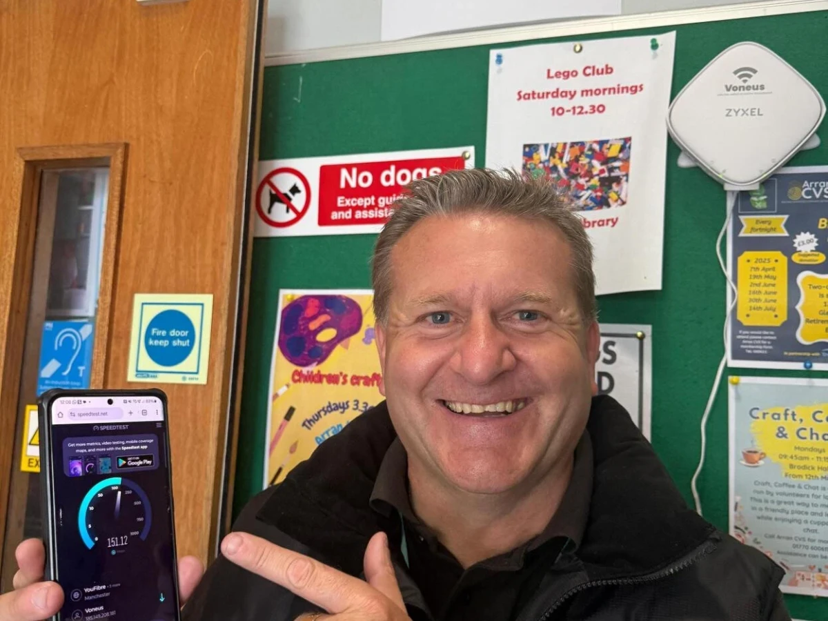 Voneus team member demonstrating free community Wi-Fi speed at Arran Library