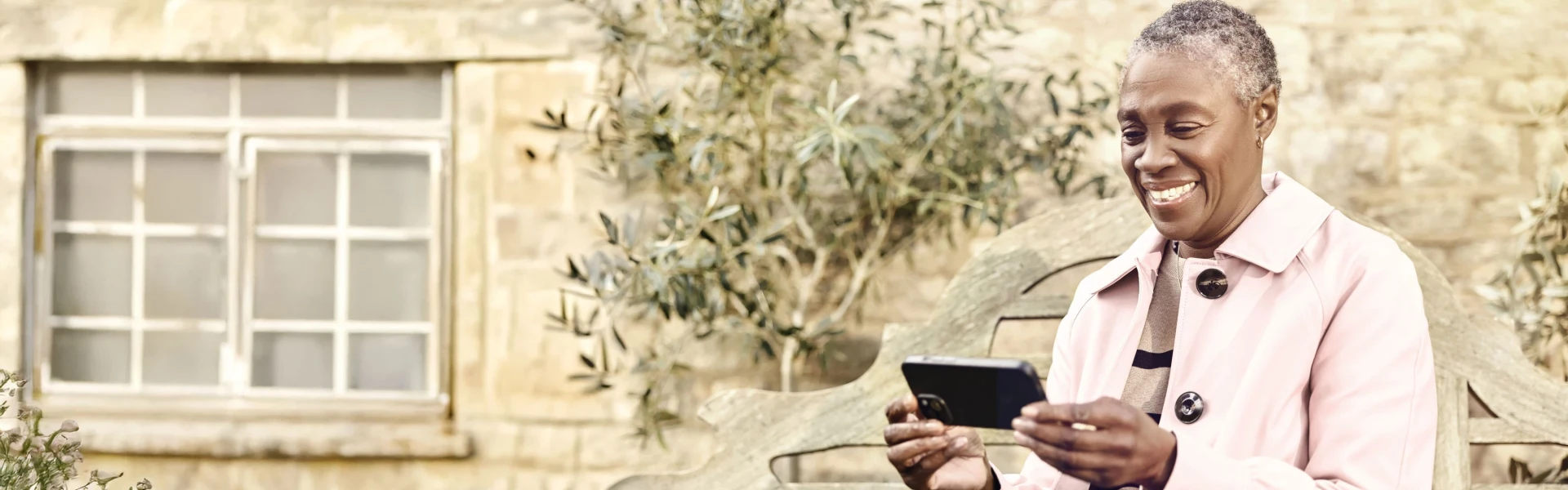 Woman using a smartphone with Voneus WiFi Mesh at home